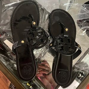 A pair of Tory Burch sandal with normal wear and tear. Gently worn sandals